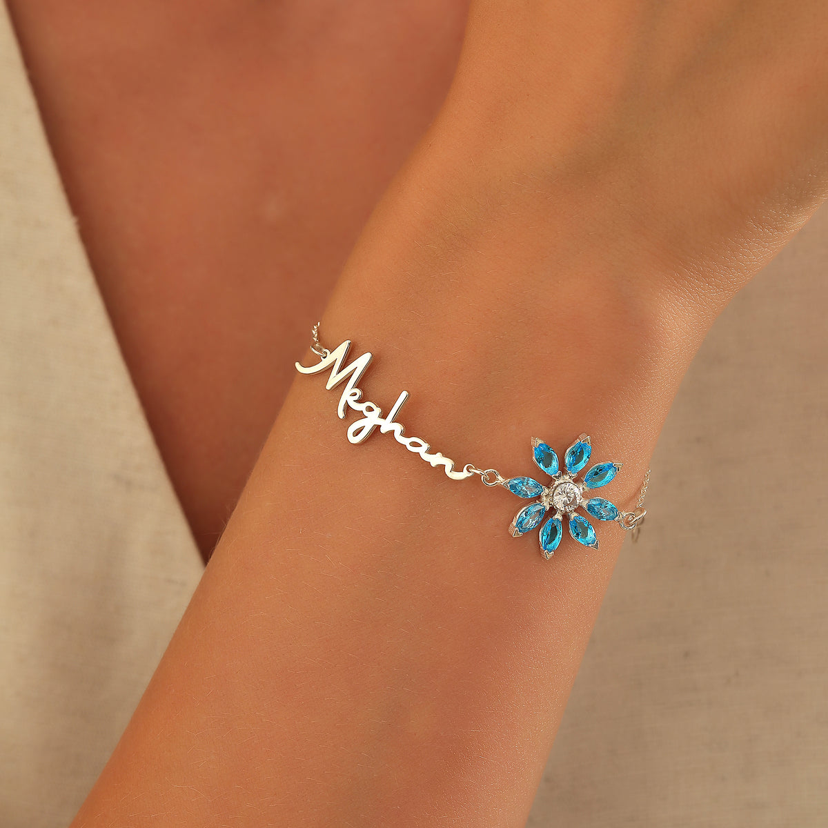 Name bracelet with birth flower birthstone charm, crafted in the Artizian studio