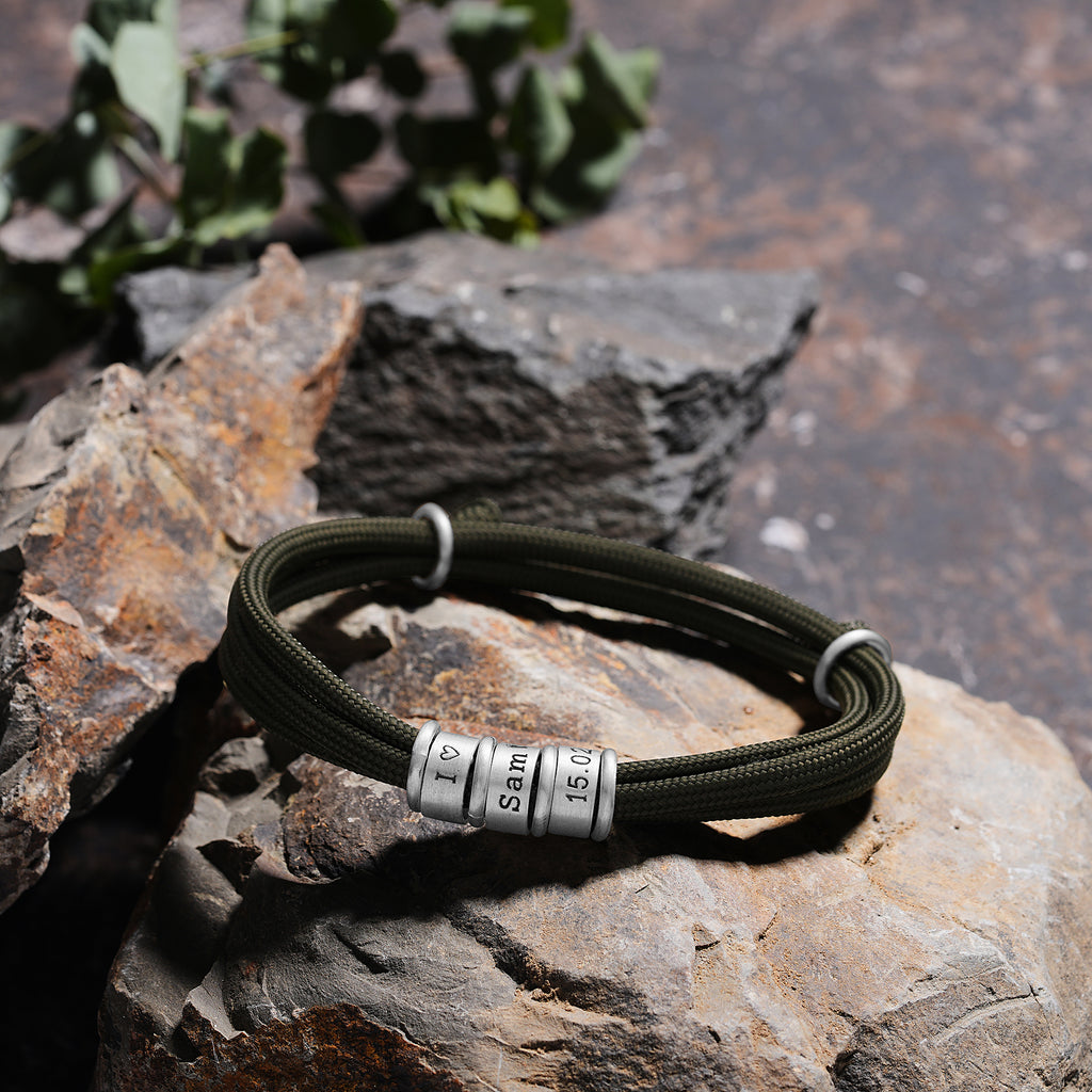 Men's paracord bracelet with personalized engraved beads, crafted in the Artizian studio