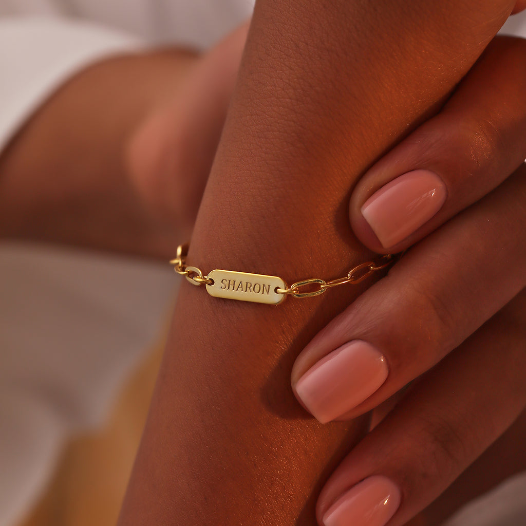 Paperclip chain bracelet with personalized engraved charms, crafted in the Artizian studio