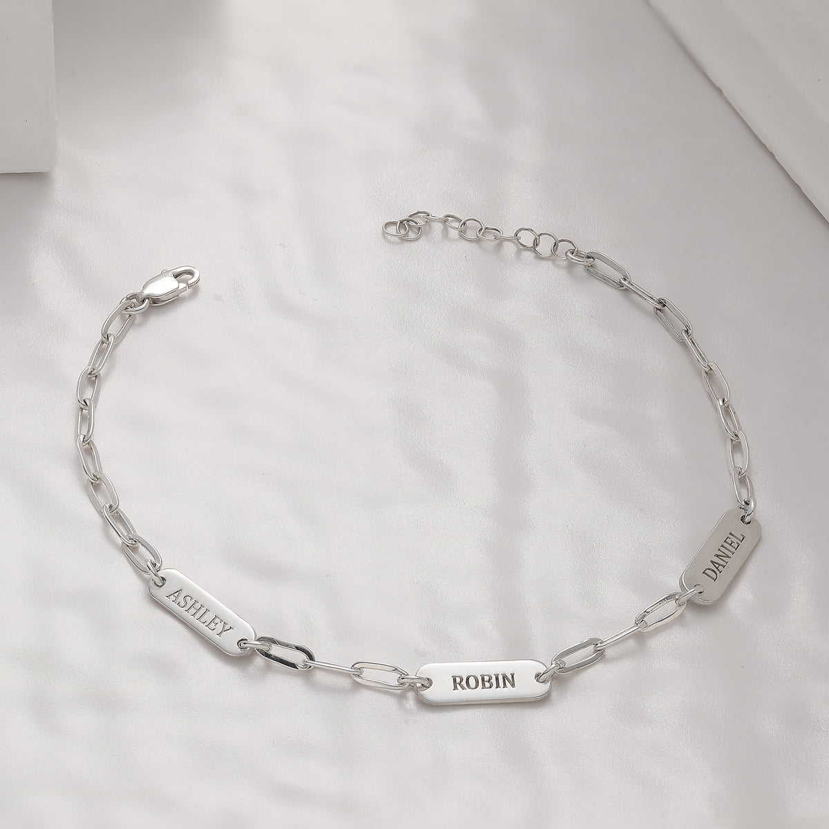 Paperclip chain bracelet with personalized engraved charms, crafted in the Artizian studio